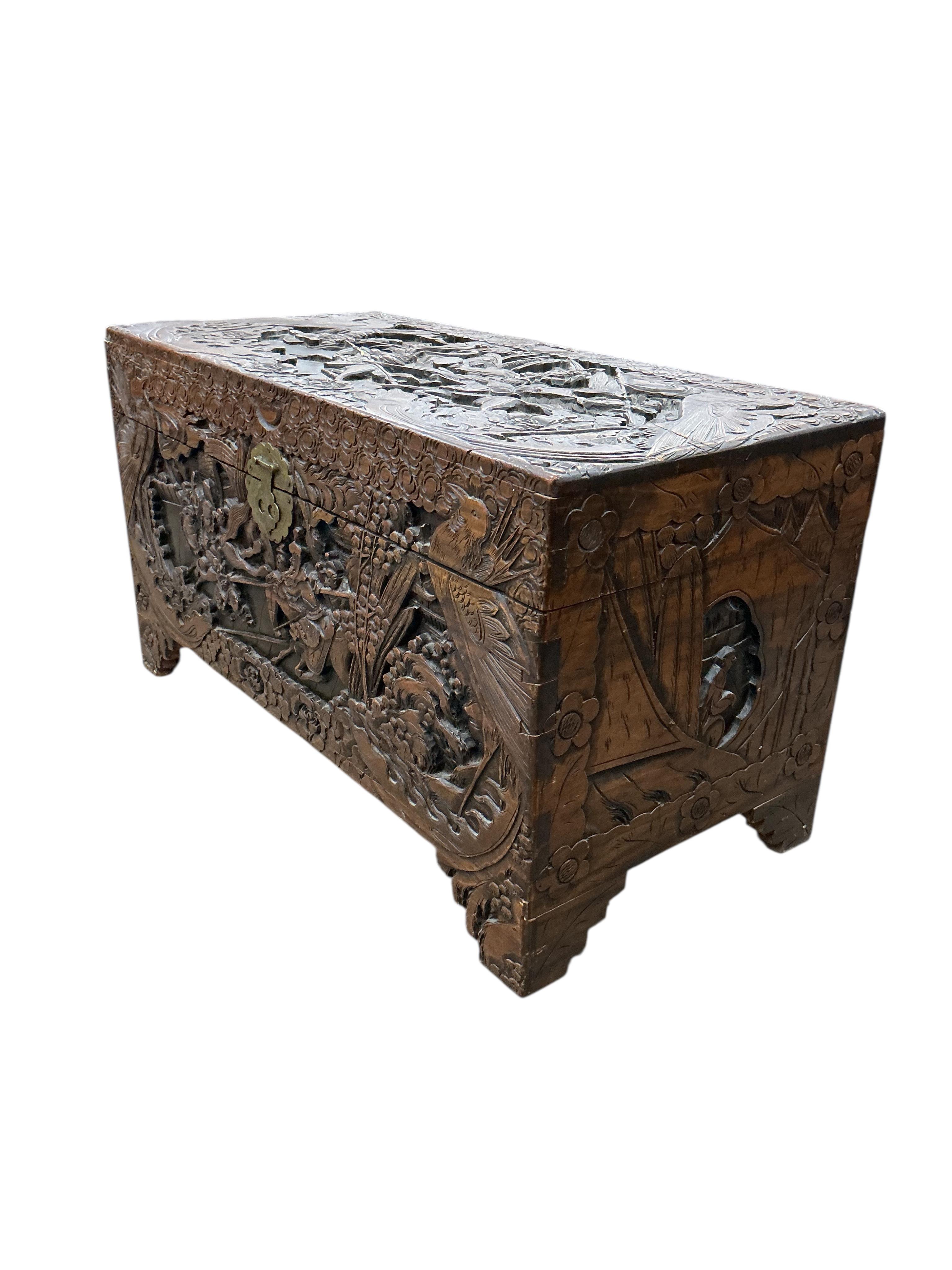 A Chinese carved camphorwood trunk, width 97cm, depth 47cm, height 54cm
